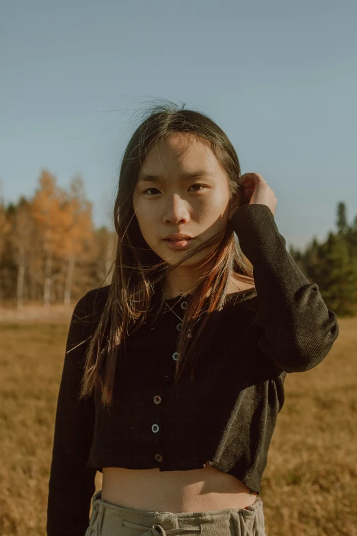 the young woman is posing in front of the camera