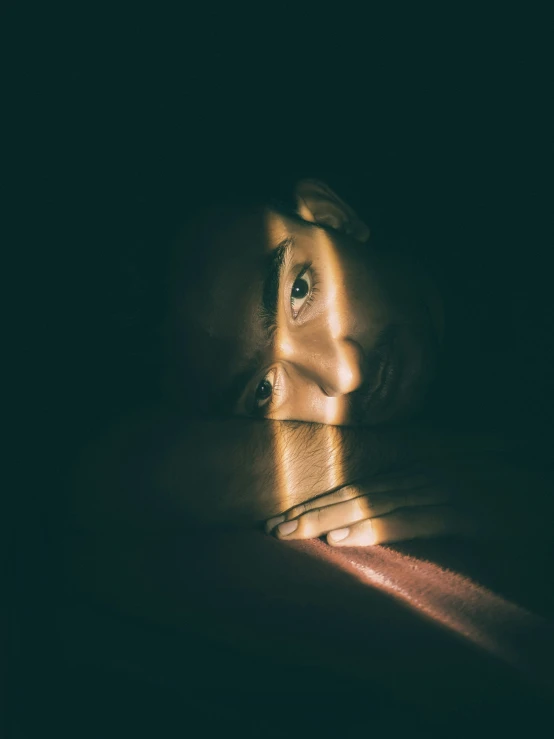 a woman's face is seen through the shadows in this artistic image