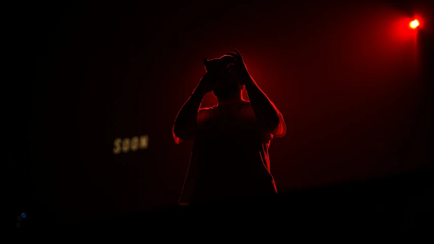 man holding his head while walking down the street