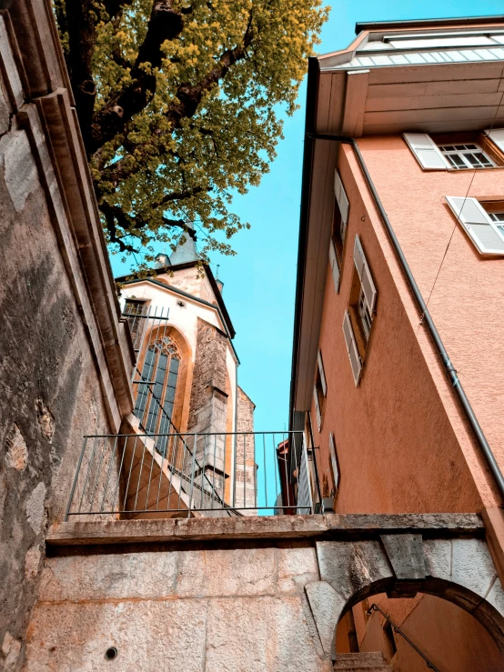 the top half of a building with an iron balcony