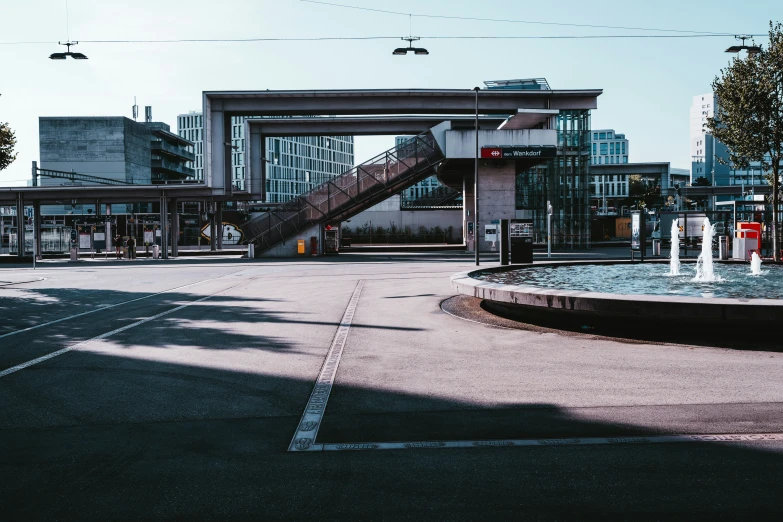 a very long city street with some type of bridge in the background