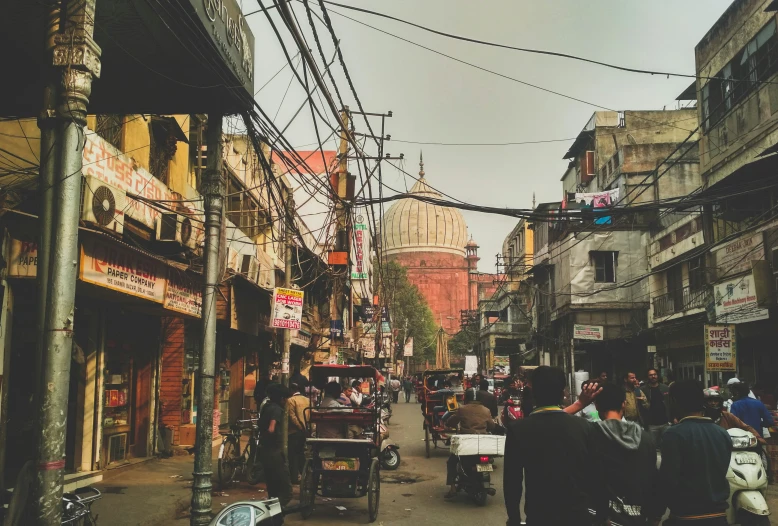 an old city street with many shops and some people