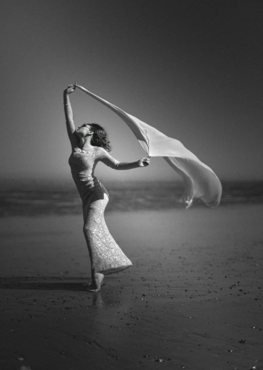 a woman with a scarf on a beach