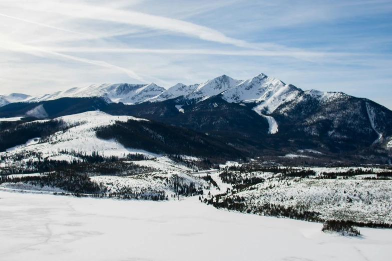 a snowy mountain covered in snow with a sky background