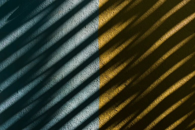 shadows on the top and bottom of a corrugated fence