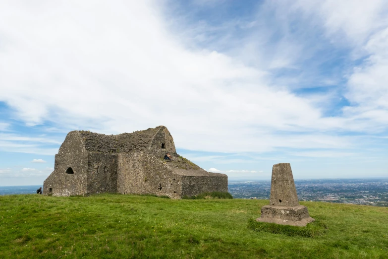 a stone structure on top of a hill