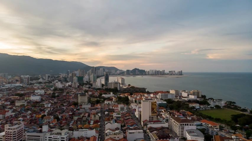 a city area with high rise buildings and water in the background