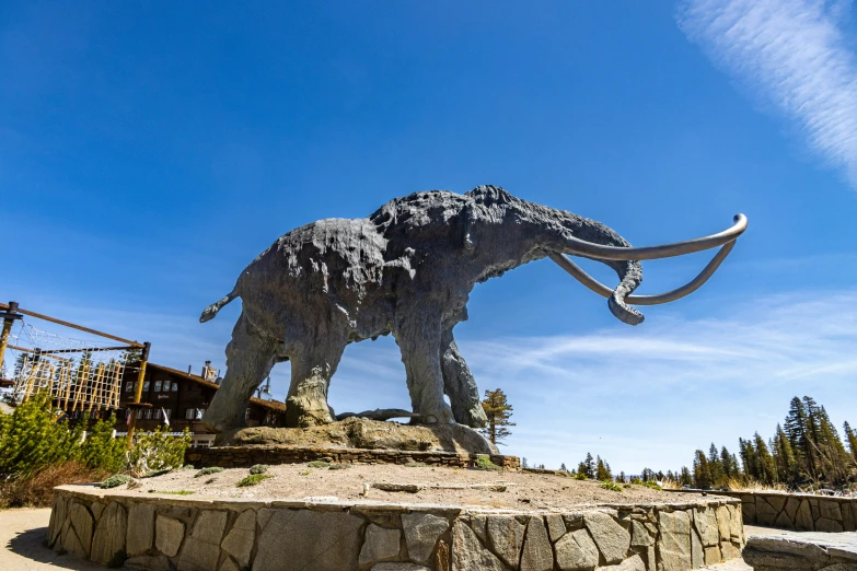 an elephant statue is in the middle of a park