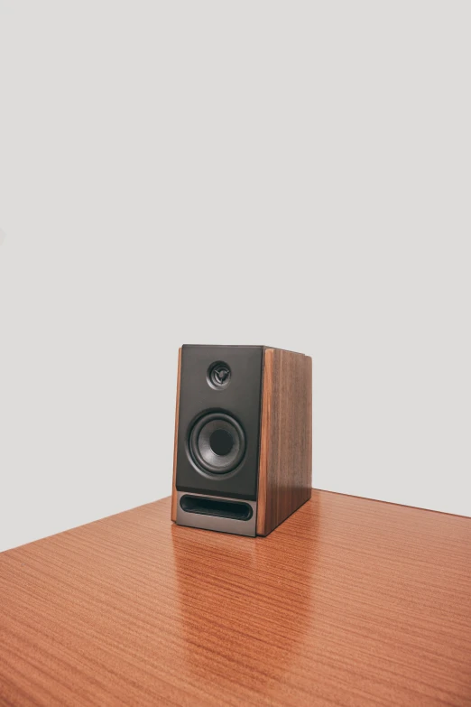 a wooden desk with a speaker on top of it