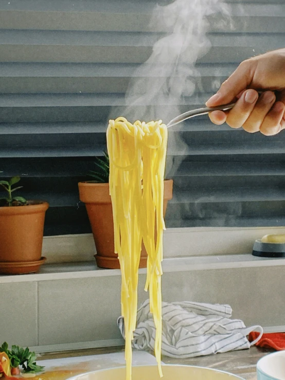 the woman is eating spaghetti with  sauce on a fork