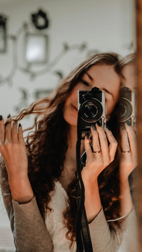 a woman standing with her camera in her hands