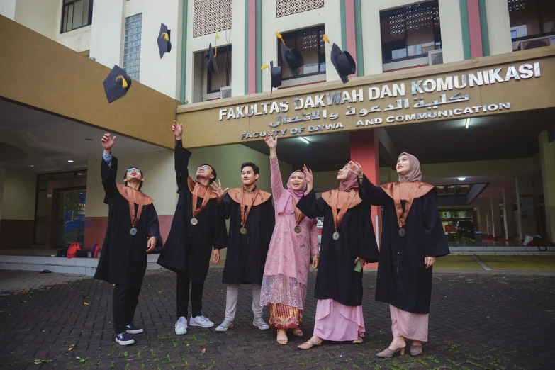 a group of women dressed in black and orange pose for a po