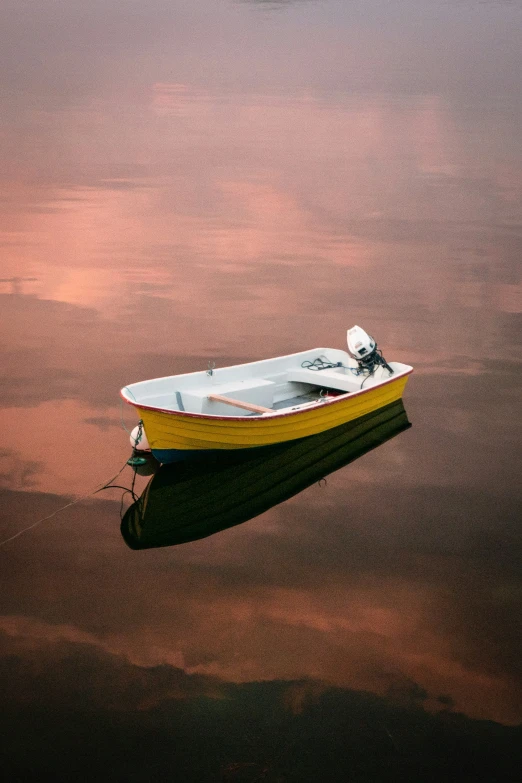 a yellow and black boat floating on top of water