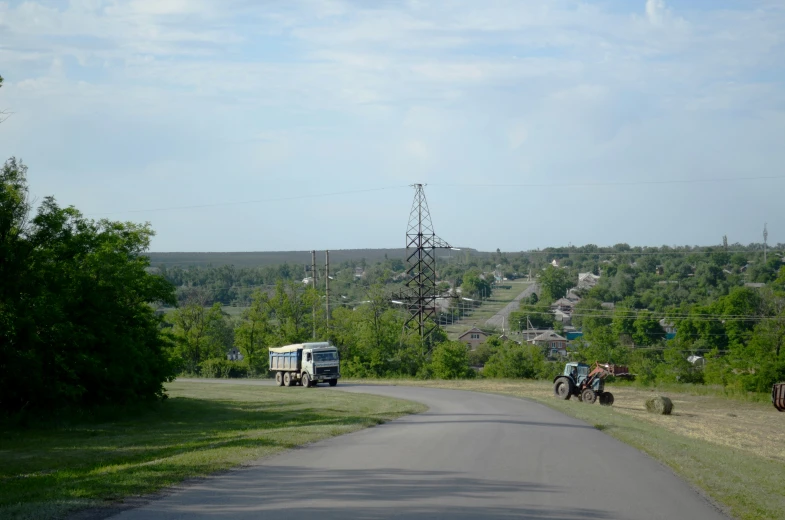 a street view with people riding on tractors down the road