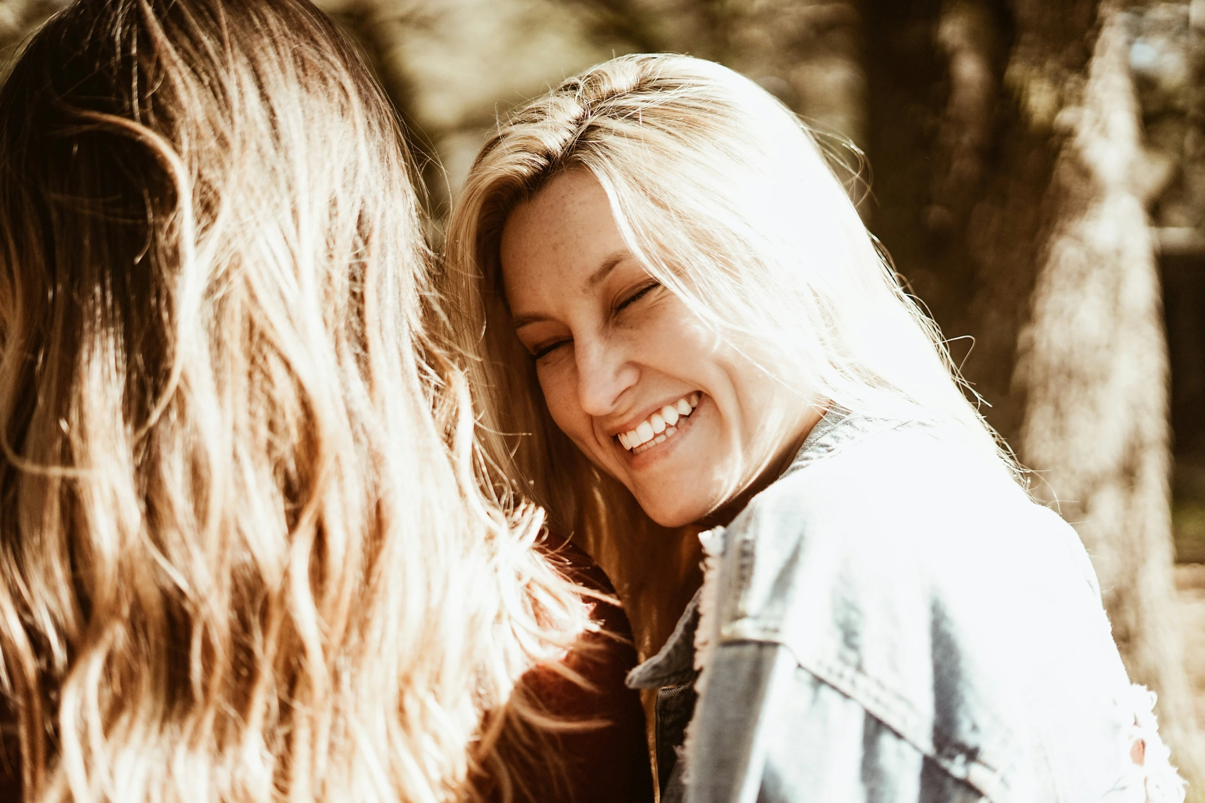 a close up of two people laughing at each other