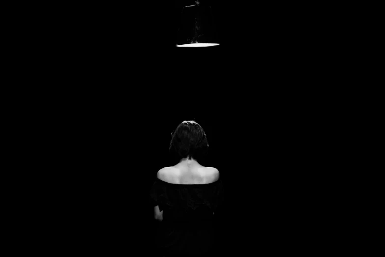 a woman with  sitting in the dark