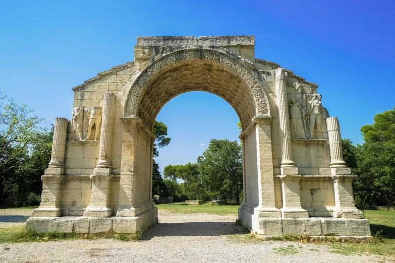 an arch built in some sort of stone with statues