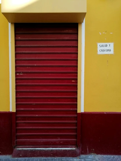 a red closed roller up door on a building