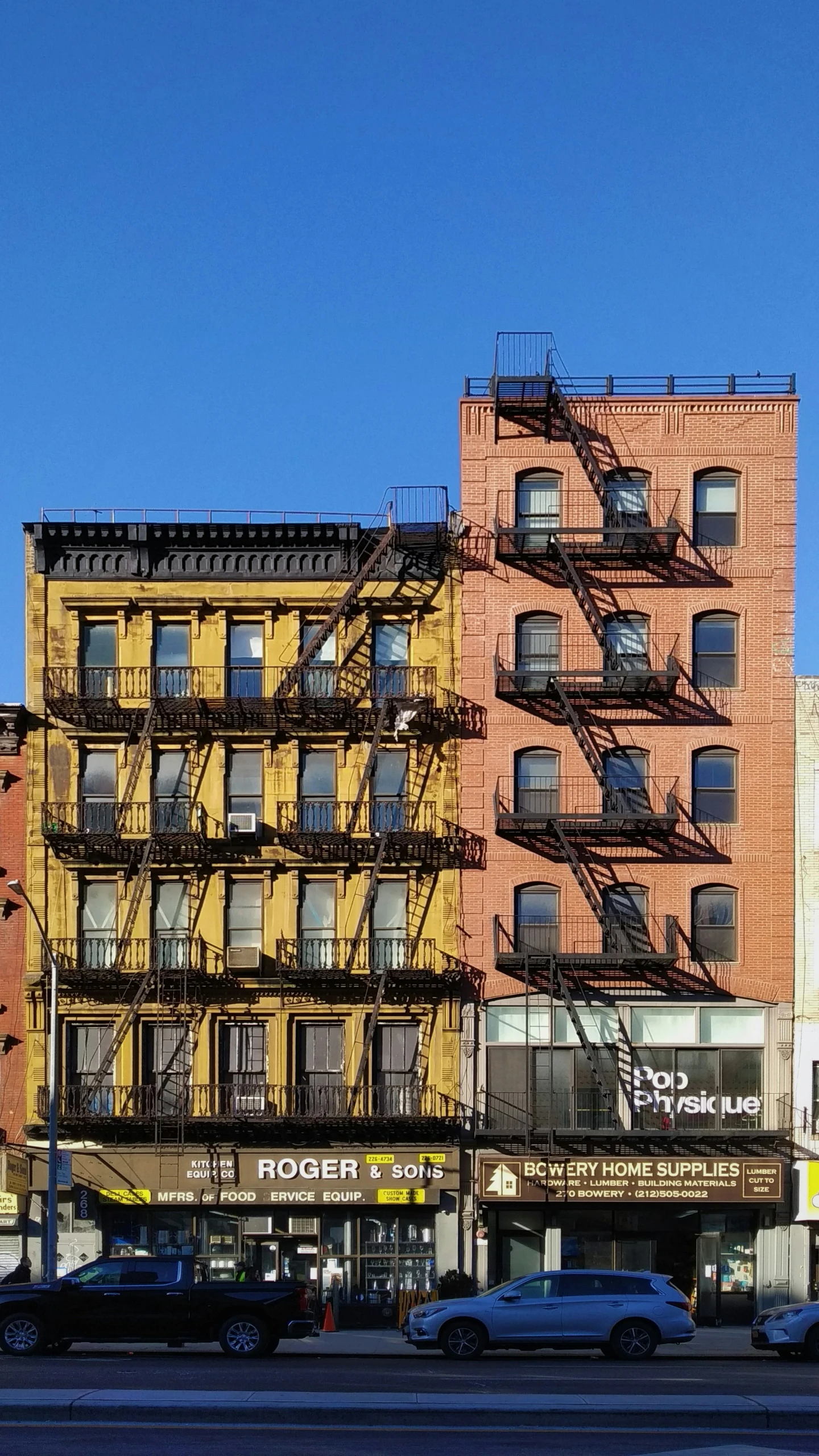 a fire escape near a large building with many stairs going down it