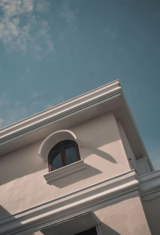 a clock is at the top of a white building