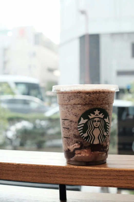 a drink sitting on a table on a rainy day