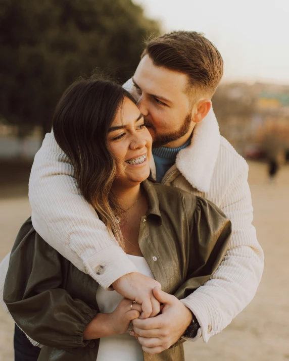 man and woman standing together on the beach