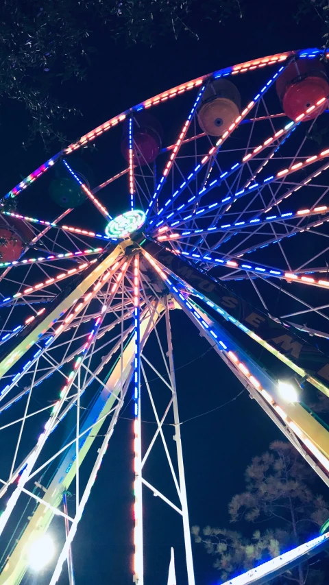 a ferris wheel is lit up at night