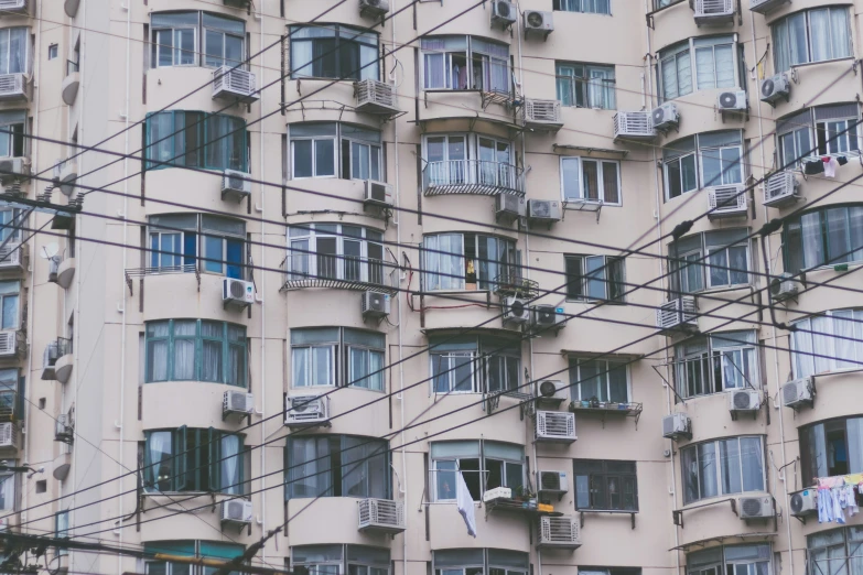 the exterior of a tall building with lots of windows