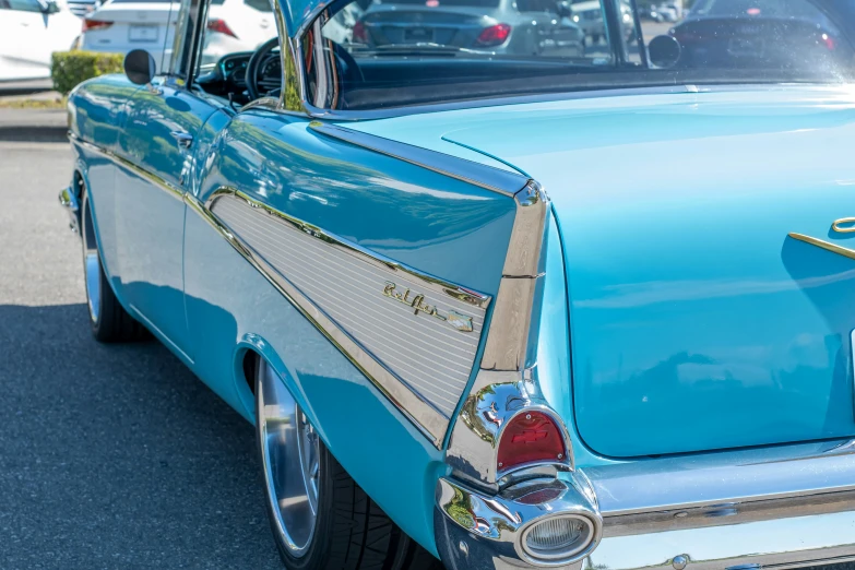 the back of an old car with shiny chrome