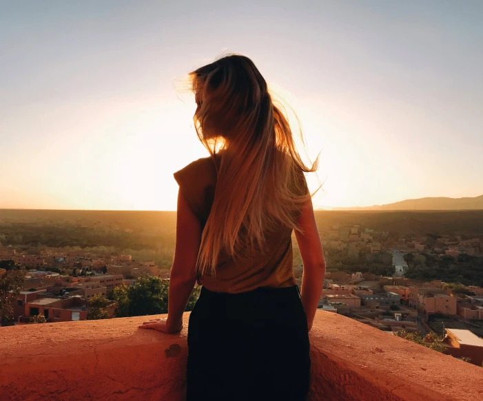 a woman with long blonde hair and wearing a skirt