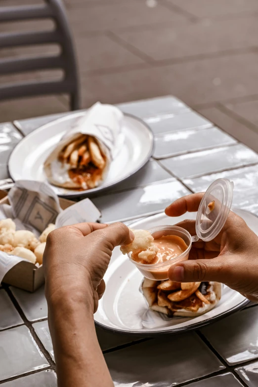 a person is eating from a container on a table