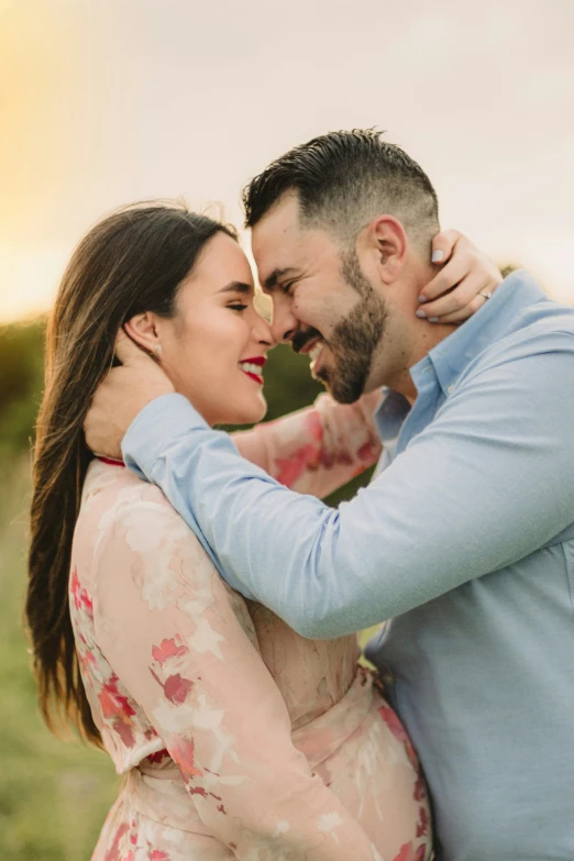 a man is holding his woman in his arms and he is smiling