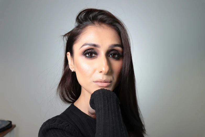 a woman poses with long black hair and dark eyes