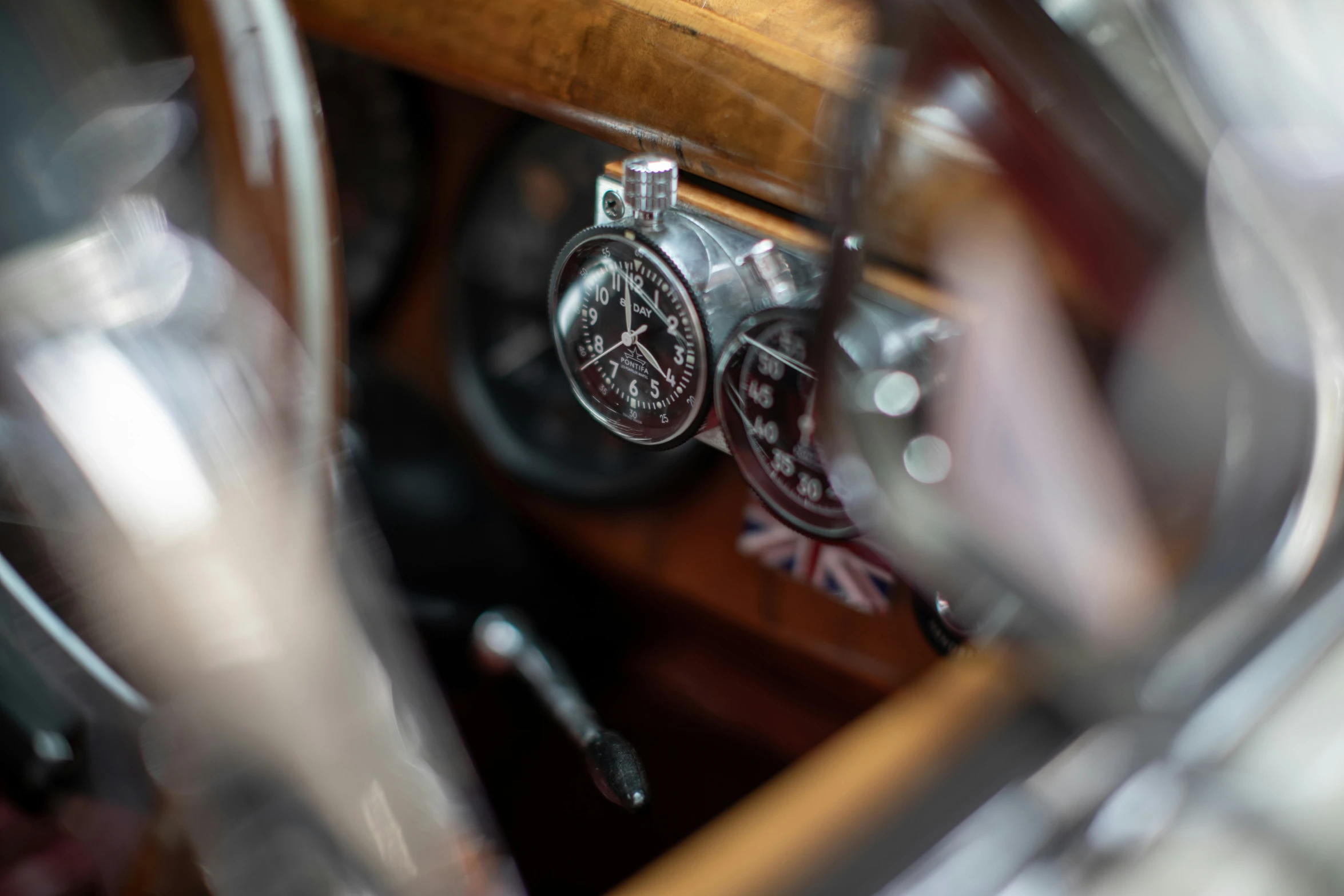 steering wheel with dial on wooden dashboard vehicle