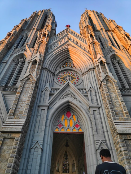 the people are standing outside of the church