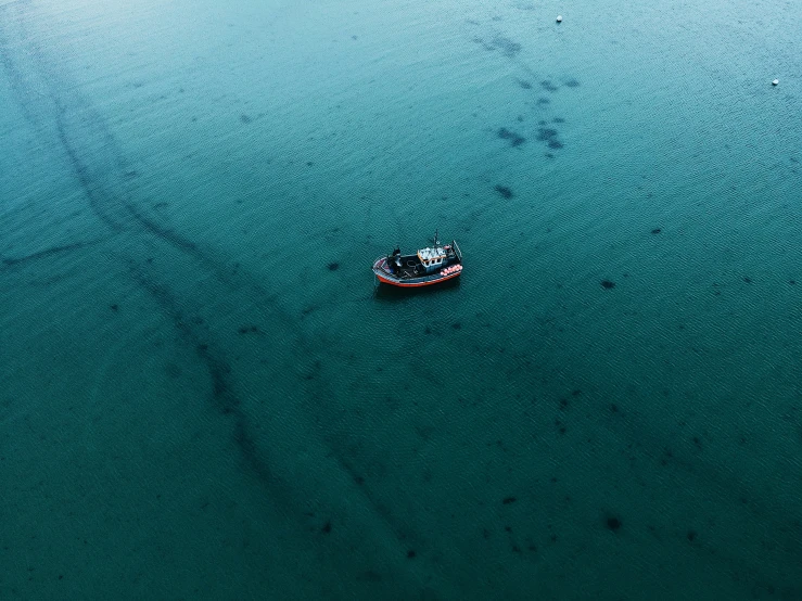 an aerial s of a boat floating on water