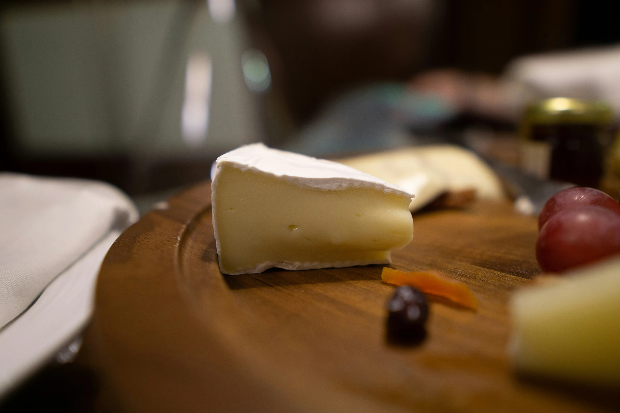 a  board with several types of cheese on it