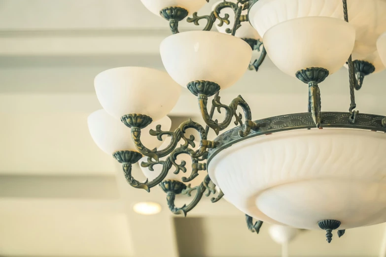 a fancy chandelier hangs in the ceiling in a room