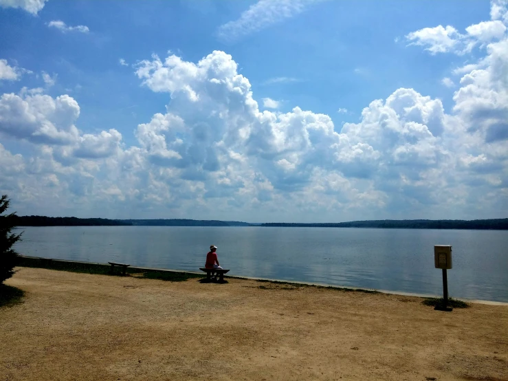 a person riding on a bicycle near the water