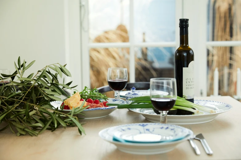 a table topped with plates of food and a wine bottle