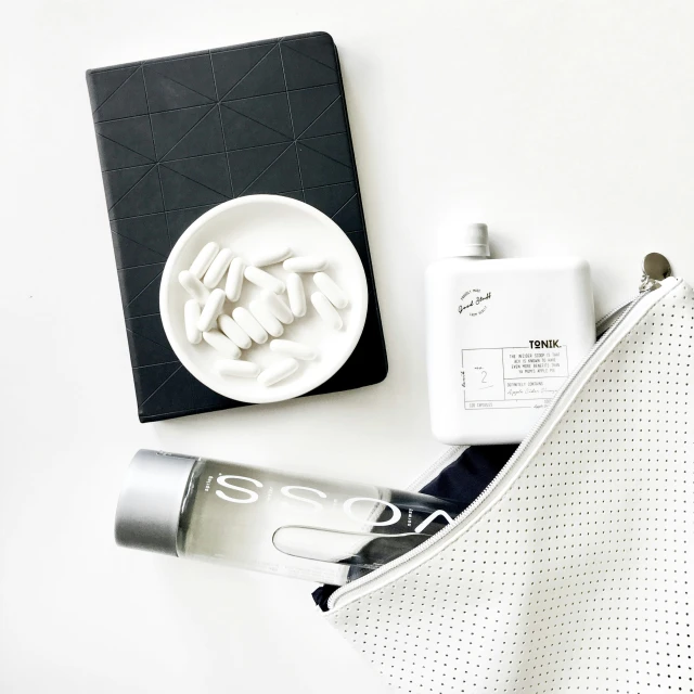 this is an image of a toiletries set including a cup, soap dish, and a book