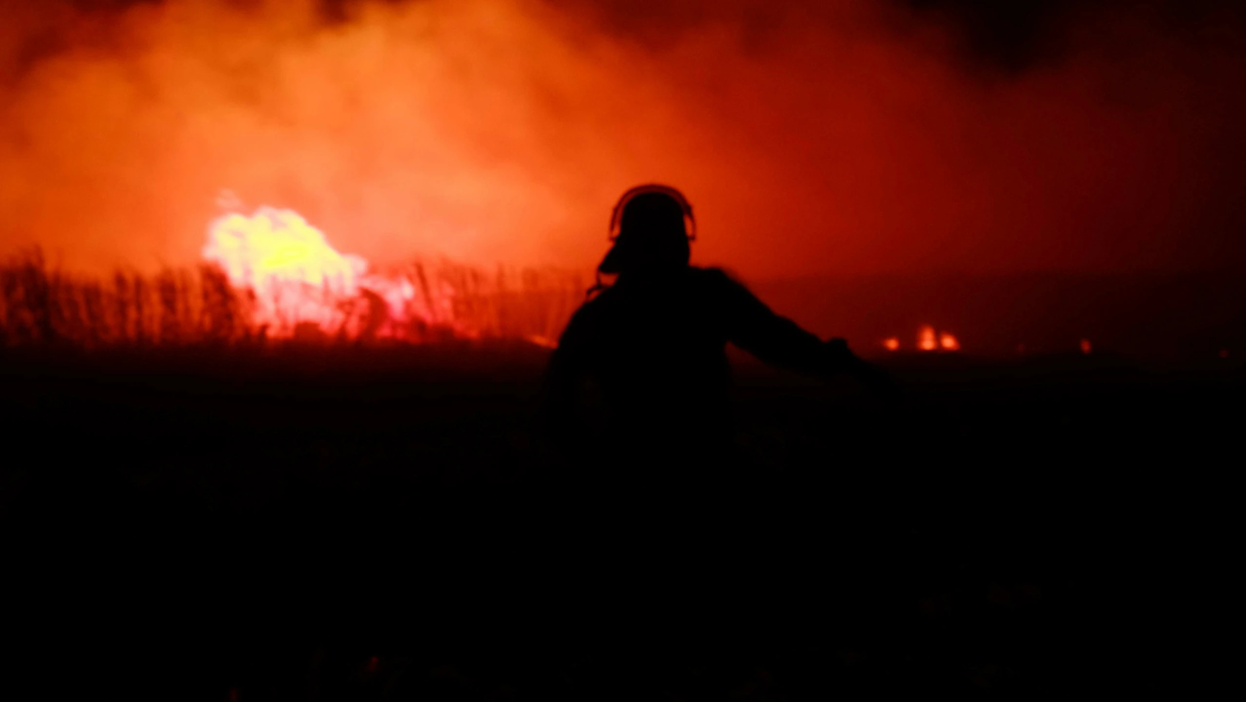 a woman that is looking at a fire