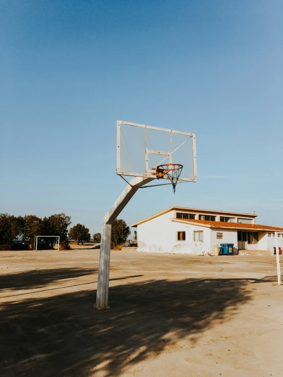 a basketball board being mounted to a pole