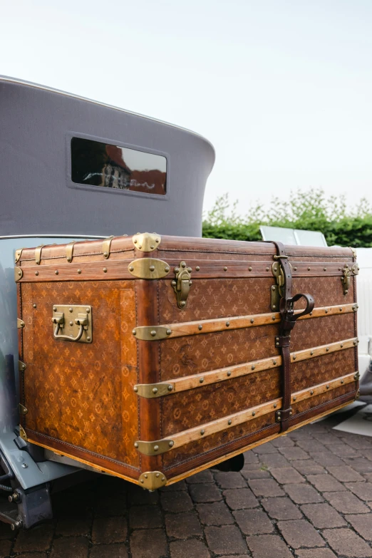 a trunk sitting in the bed of an old vehicle