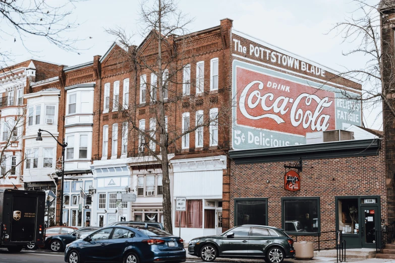 cars are parked in front of a coca cola restaurant