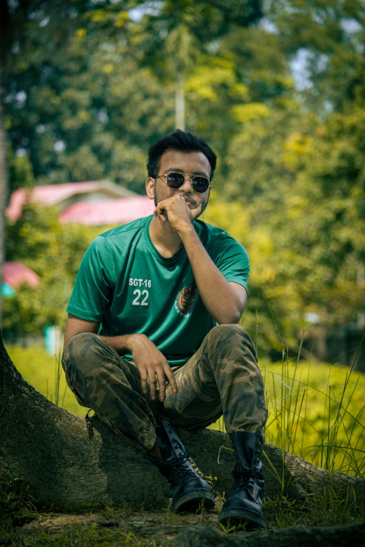 a man sits on a rock while posing for the camera