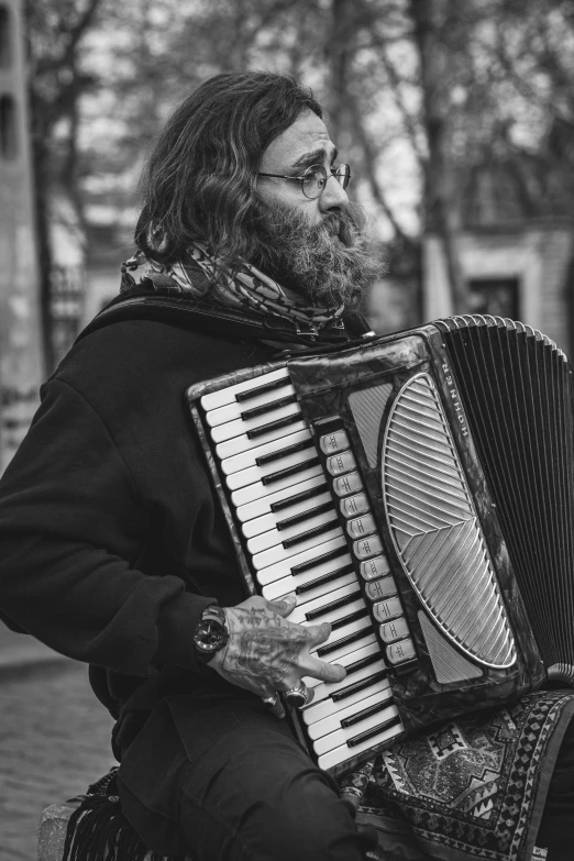 a man is holding an accordian in front of him