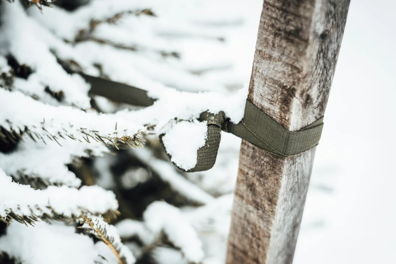 the snow has been attached to the wooden post