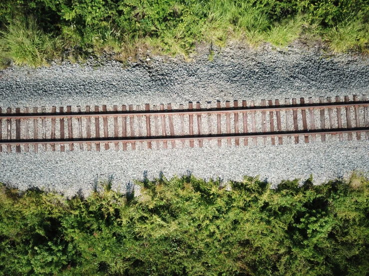 a train track that is on a gravel road