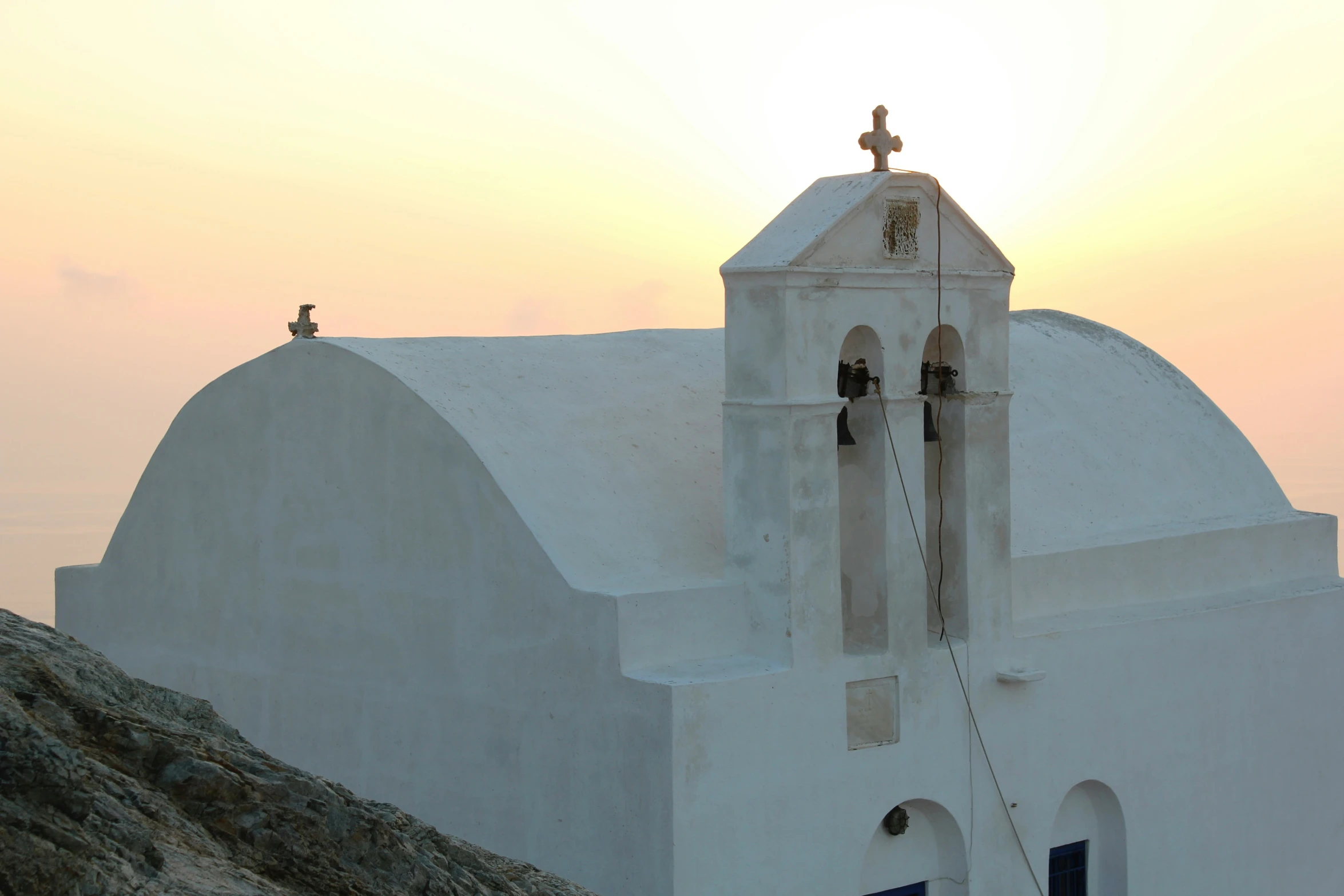 there is a small church at the top of a hill